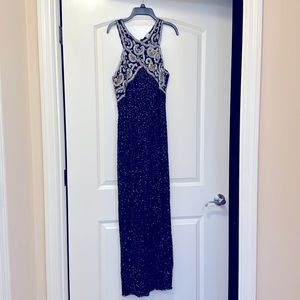 Long beaded formal gown. Top  of gown has gold  and silver beading